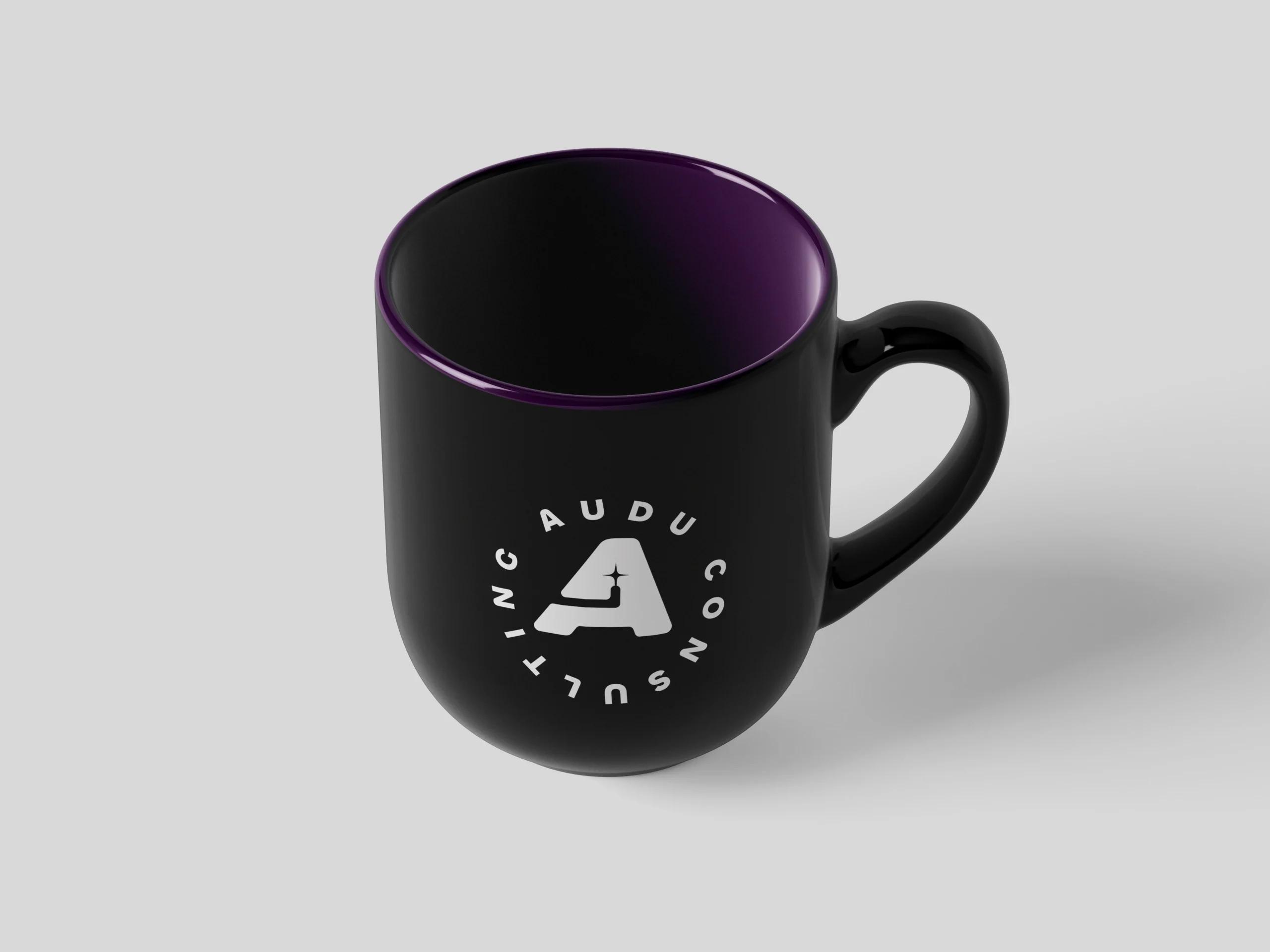 Black AUDU Consulting mug with the circular badge